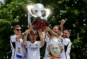 Toni Kroos (L) with this season's La Liga trophy alongside teammates Luke Modric, Nacho Fernandez and Dani Carvajal
