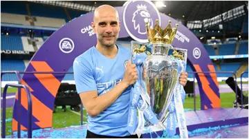 Pep Guardiola celebrates with the Premier League trophy after their side finished the season as Premier League champion at Etihad Stadium. Photo by Michael Regan.