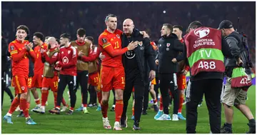 Gareth Bale and manager Robert Page together after their 2-1 victory during the 2022 FIFA World Cup Qualifier knockout round play-off match between Wales and Austria. Photo by Charlotte Wilson.