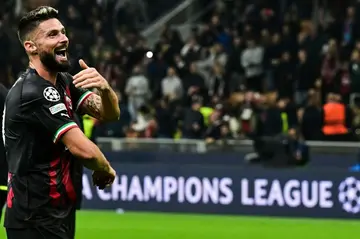 Olivier Giroud scored twice to fire AC Milan into the knockout phase for the first time in nine years