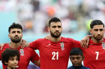 Iran players including captain Alireza Jahanbakhsh (R) did not sing their anthem before the match against England