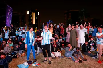 Argentina fans watching their side's World Cup semi-final victory on a big screen in Doha -- the Albiceleste are a firm favourite among migrant workers in Qatar