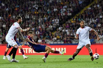 Former Real Madrid great Sergio Ramos (L) scored a painful own goal for Sevilla against Barcelona on Friday night in La Liga