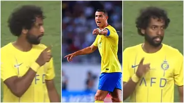 Abdulmajeed Al-Sulaiheem counts his Al-Nassr teammates as captain, Cristiano Ronaldo gestures during a game.