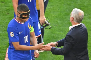 France coach Didier Deschamps shakes hands with Kylian Mbappe at the end of the 1-1 draw with Poland on Tuesday