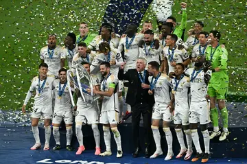 Real Madrid players celebrate with the Champions League trophy after beating Borussia Dortmund at Wembley