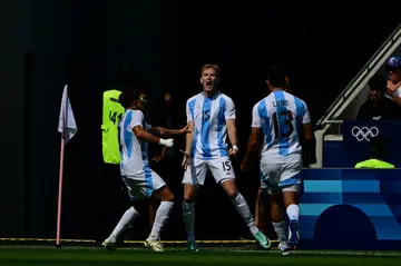 Luciano Gondou (C) celebrates with teammates after scoring Argentina's second goal against Iraq in Lyon