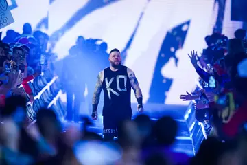 Kevin Owens walks out prior to the WWE and Universal Championship