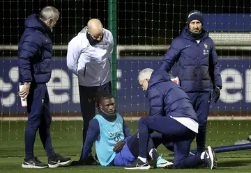 Eduardo Camavinga is helped by medical staff after injuring his knee in a training session with his French international teammates