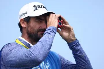 A general view of a caddie using a range finder during a practice round for The 149th Open at Royal St George’s Golf Club on July 13, 2021 in Sandwich, England.