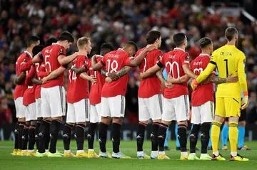 Manchester United players pause for a minute's silence following the death of Queen Elizabeth II