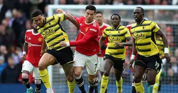 Cristiano Ronaldo of Manchester United battles for possession with Joshua King of Watford FC at Old Trafford on February 26, 2022 in Manchester, England. (Photo by Jan Kruger/Getty Images)