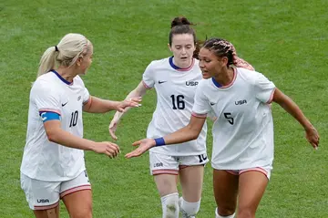 Trinity Rodman (R) celebrates with teammates after putting the United States ahead in extra time against Japan