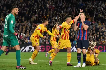 Barcelona's Polish forward Robert Lewandowski (2R) reacts to missing a chance against Girona in the draw on Monday