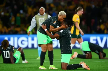 Nigeria defender Onome Ebi (L) and Osinachi Ohale celebrate their team's victory