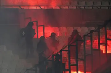 French riot police move in after flares were set off during the UEFA Champions League match between Marseille and Eintracht Frankfurt at Stade Velodrome