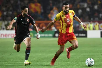 Marwan Attia (L) of Al Ahly challenges Ghaylene Chaalali of Esperance during the first leg of the 2024 CAF Champions League final in Tunisia.