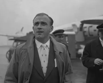 Alfredo Di Stefano of Real Madrid arrive at Heathrow Airport for the European Cup semi-final second leg against Manchester United on April 22, 1957