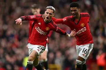 Manchester United's Brazilian midfielder  Antony (L) celebrates with Amad Diallo (R)