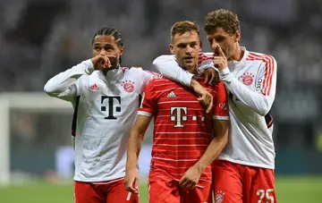 (LtoR) Bayern Munich's German midfielder Serge Gnabry, Bayern Munich's German midfielder Joshua Kimmich and Bayern Munich's German forward Thomas Mueller react at the end of the German first division Bundesliga football match between Eintracht Frankfurt and FC Bayern Munich in Frankfurt am Main, western Germany on August 5, 2022.