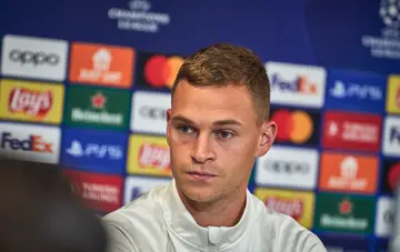 Joshua Kimmich of Fc Bayern Muenchen at the Press conference listening to a journalist at Parken Stadium