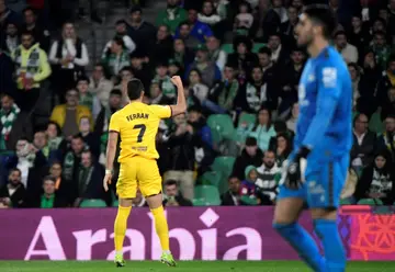 Barcelona forward Ferran Torres scored a hat-trick as his team snatched victory against Real Betis to stay in the title race