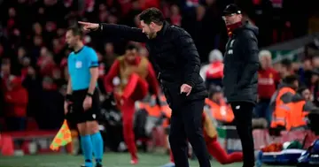Diego Simeone reacts as Liverpool's Jurgen Klopp (R) looks on during the UEFA Champions league Round of 16 second leg football match between Liverpool and Atletico Madrid IN March 11, 2020. (Photo by JAVIER SORIANO)