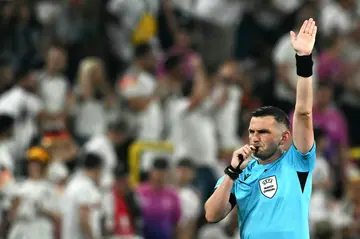British referee Michael Oliver gestures for a VAR decision during the Euro 2024 last 16 game between Germany and Denmark