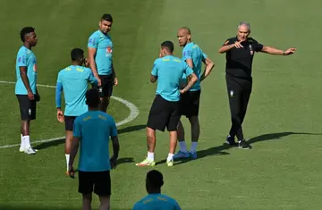 Brazil coach Tite (right, in black) has been criticised for perceived defensive tactics but his team has scored more than two goals per game