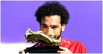 Mohamed Salah poses for a photo with his Premier League Golden Boot Award after the Premier League match between Liverpool and Brighton at Anfield on May 13, 2018. Photo by Michael Regan.
