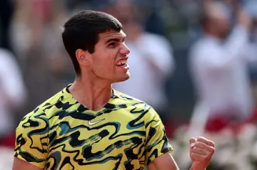 King of the court...and marbles: Carlos Alcaraz celebrates beating Karen Khachanov