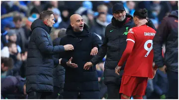 Jurgen Klopp intervenes during a dispute between Pep Guardiola and Darwin Nunez during the Premier League match between Manchester City and Liverpool FC at Etihad Stadium. Photo by Simon Stacpoole.