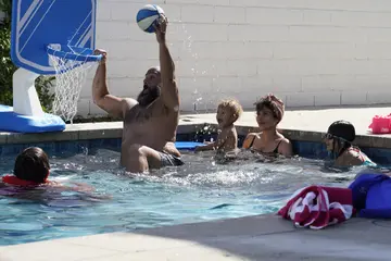 A man tries to make a score in a water basketball game