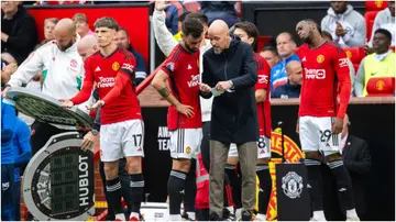 Erik ten Hag interacts with Bruno Fernandes during the Premier League match between Manchester United and Brighton at Old Trafford. Photo by Ash Donelon.