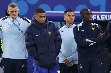 Mbappe watches the penalty shoot-out against Portugal from the sidelines having been substituted in extra time