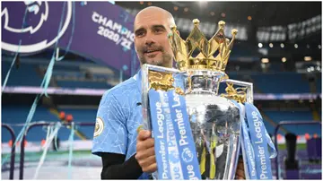 Pep Guardiola celebrates with the Premier League trophy following the Premier League match between Manchester City and Everton at Etihad Stadium in 2021. Photo by Michael Regan.