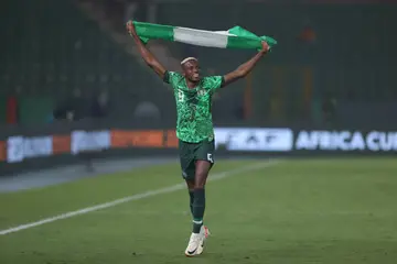Victor Osimhen celebrates with the Nigerian flag after the Super Eagles defeated South Africa in the AFCON semi-final.