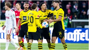 Jadon Sancho and Niclas Fuellkrug interact before a penalty kick during the Bundesliga match between 1. FC Köln and Borussia Dortmund. Photo by Leon Kuegeler.