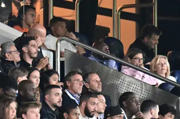 Kylian Mbappe looks on from the stands in Paris Saint-Germain's season opener after being left out over a contract dispute