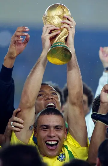 Super striker: Ronaldo hoists the World Cup trophy aloft in 2002