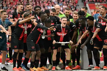 Bayer Leverkusen midfielder Florian Wirtz lifts the Bundesliga trophy