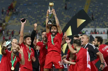 Hussein el Shahat (C) holds the CAF Champions League trophy after Al Ahly of Egypt defeated Wydad Casablanca of Morocco in the 2023 final.