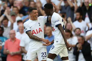 Tottenham's Pedro Porro and Pape Sarr (R) celebrate against Manchester United