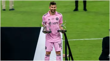 Lionel Messi stands with tournament trophies for best play and top scorer after his team's victory during the Leagues Cup final match between Nashville SC and Inter Miami CF. Photo by Nick Tre. Smith.