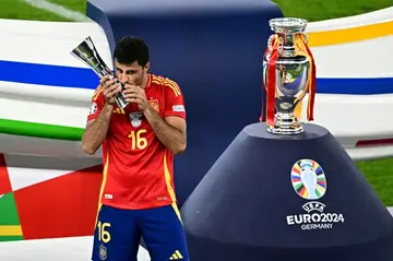 Rodri kisses the player of the tournament award after Spain won Euro 2024 by beating England 2-1 in the final