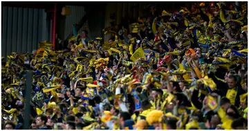 Villarreal fans hold up scarfs prior to the UEFA Champions League Semi Final Leg One match between Liverpool and Villarreal at Anfield. Photo by Pedro Salado.