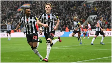 Anthony Gordon celebrates with Joe Willock after scoring the winning goal during the Premier League match between Newcastle United and Arsenal FC at St. James Park. Photo by Stu Forster.