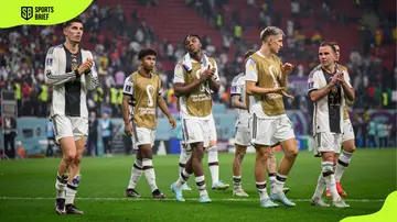 Germany players applaud fans after their last game in the 2022 FIFA World Cup