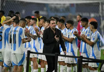 Colombia's Argentine coach Nestor Lorenzo walks past Argentina's players after the Copa America final on Sunday.