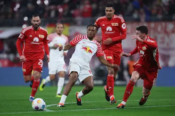 Soccer players battle for the ball during a match